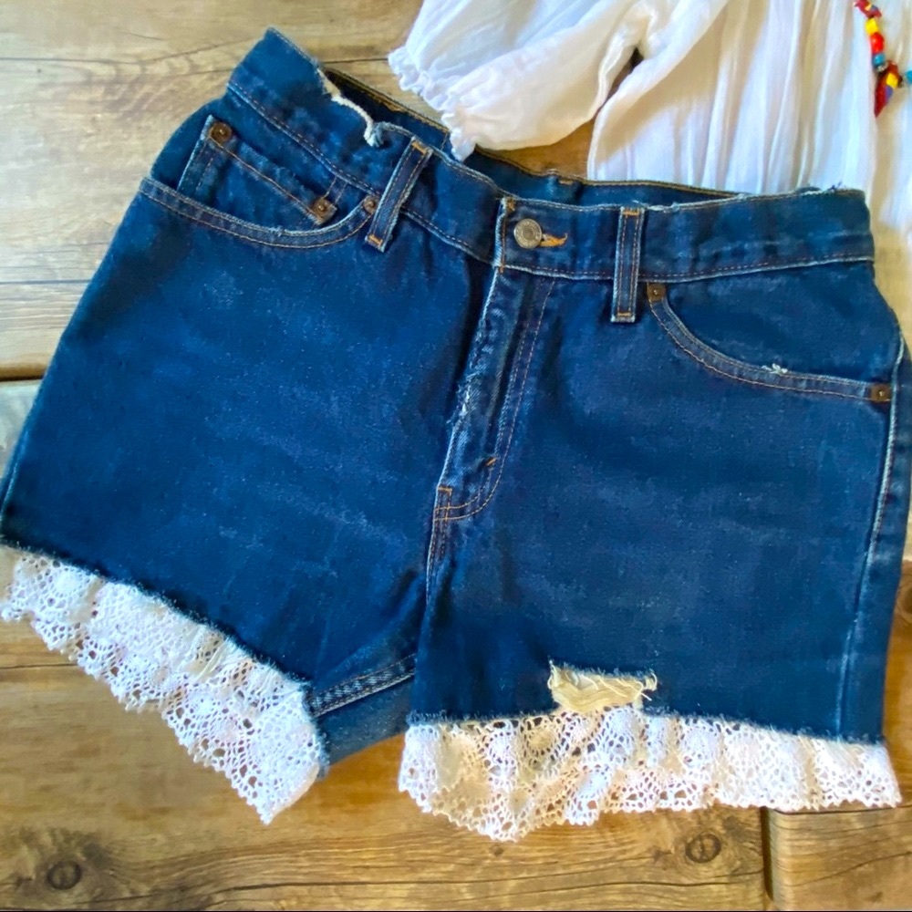 Vintage Levi’s 517 high-waist Distressed denim short w/white eyelet trim details